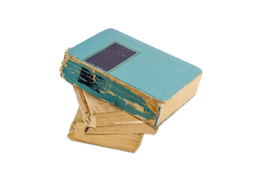 Stack of three old shabby books on a light background
