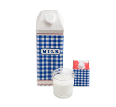 Plastic coated paper carton with pasteurized cows milk, a small carton with cream and a glass of milk on a light background
