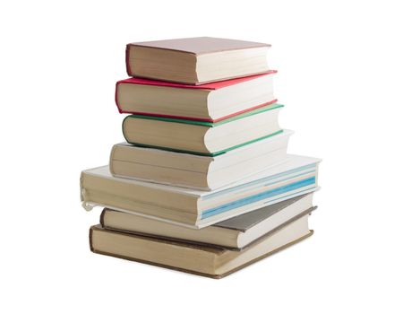 Stack of several books different formats and cover design on a light background
