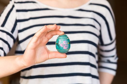 Young woman holding painted easter egg