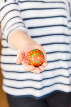 Young woman holding painted easter egg