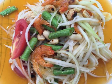 Background Thai food style. Salad with papaya, green mango and shrimps
