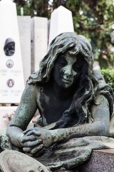 More than 100 years old statue. Cemetery located in North Italy.