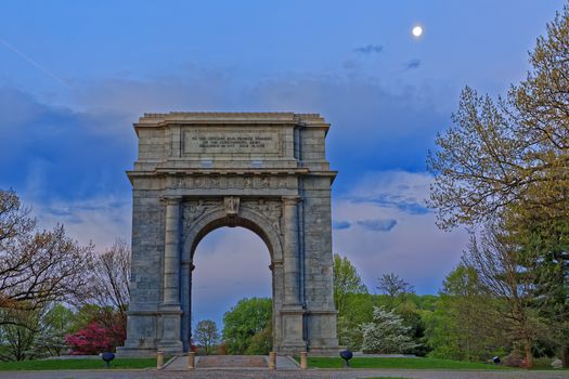 Springtime dawn with the moon shining at Valley Forge National Historical Park in Pennsylvania, USA.The National Memorial Arch is a monument dedicated to George Washington and the United States Continental Army.