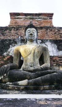 Historical Park Wat Mahathat temple bhudda statue in Sukhothai world heritage vertical