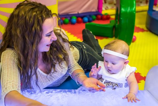 mother and child play in the children's room