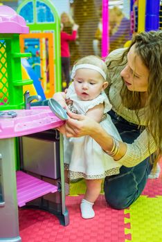 mother and child play in the children's room