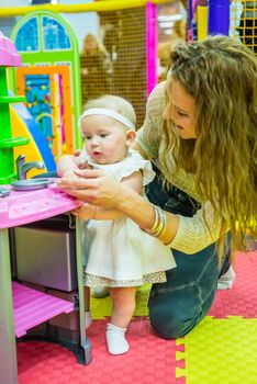 mother and child play in the children's room