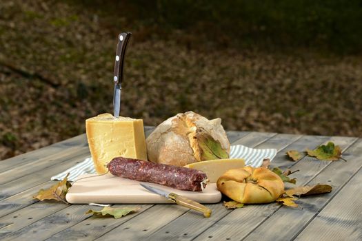 Traditional dinner of Sardinia made of cheese, sausage, bread and wine.