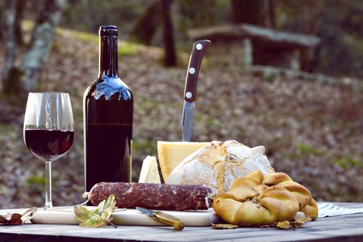 Traditional dinner of Sardinia made of cheese, sausage, bread and wine.