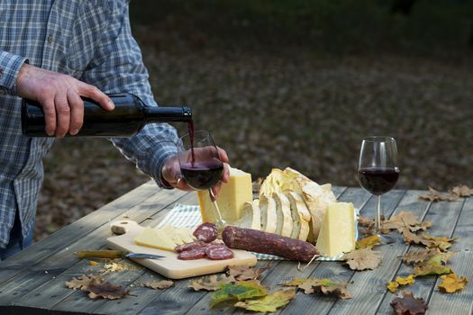 On the table in the wood pours drink the wine in the glass. Menu of sardinia