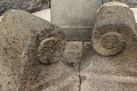 detail of two ancient volcanic stones carved