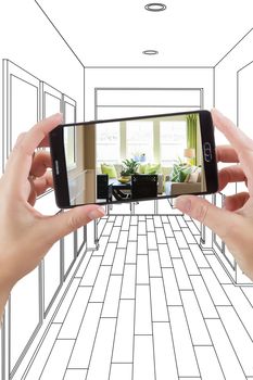 Hand Holding Smart Phone Displaying Photo of the House Hallway Drawing Behind.