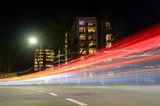 light streaks created by passing cars at an apartment building in the city