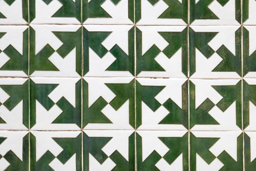 A pattern filling the frame made of green and white portugueses tiles