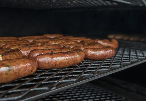 Close-up image of gourmet sausages cooking on the grill