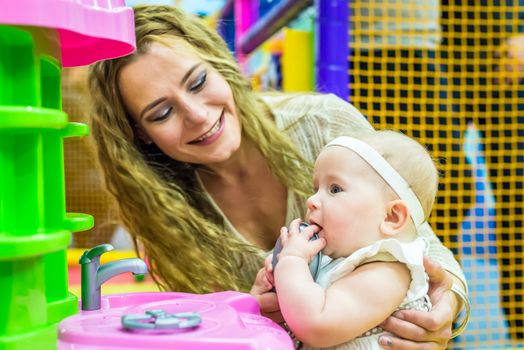 mother and child play in the children's room