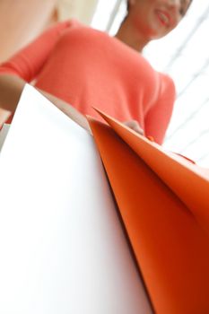 Happy smiling woman with shopping bags in mall