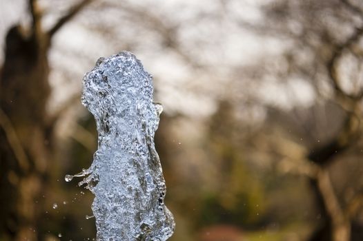 Close up of ornamental fountain water gush.