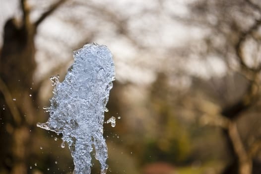 Close up of ornamental fountain water gush.