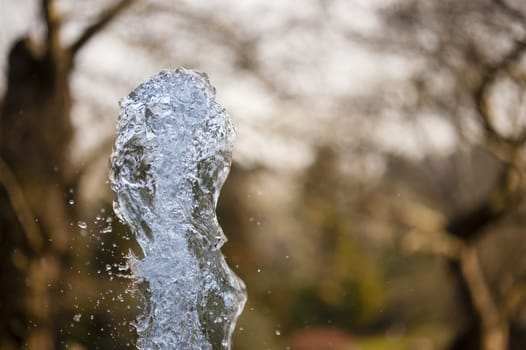 Close up of ornamental fountain water gush.