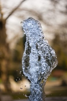 Close up of ornamental fountain water gush.