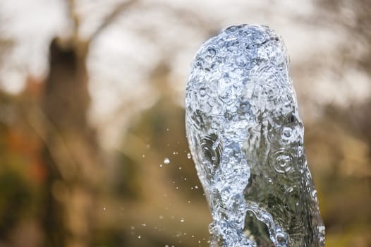 Close up of ornamental fountain water gush.