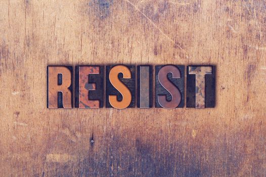 The word "RESIST" written in vintage wooden letterpress type.