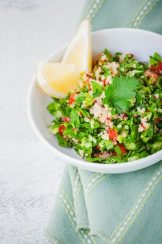 Quinoa tabbouleh salad on a wooden table.