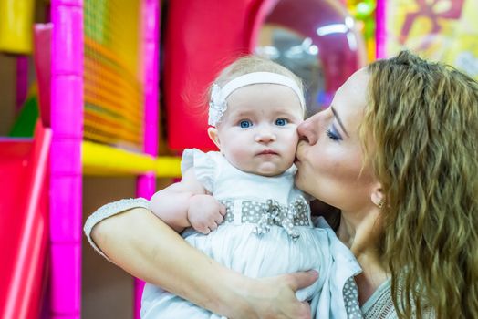 mother and child play in the children's room