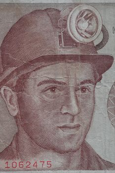 Miner in a helmet with a lantern portrait on a banknote