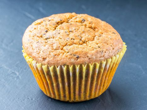 Muffin with chia seeds and lemon. Homemade muffin on black background