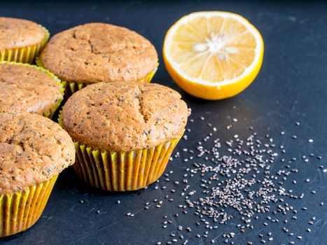 Muffins with chia seeds and lemon. Homemade muffins on black background