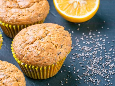 Muffins with chia seeds and lemon. Homemade muffins on black background