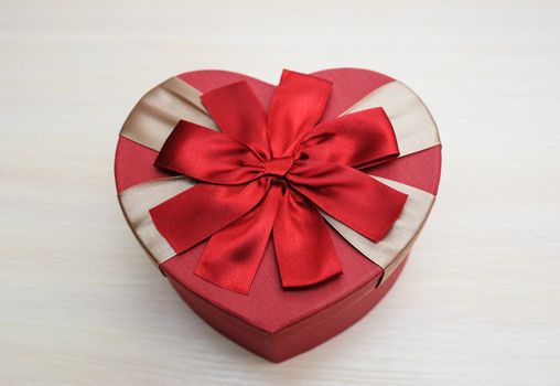 red box in form of heart with a bow on Valentine's Day.