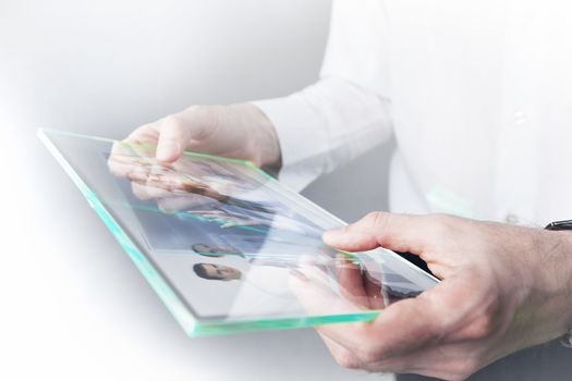 Man holding in hands futuristic glass tablet