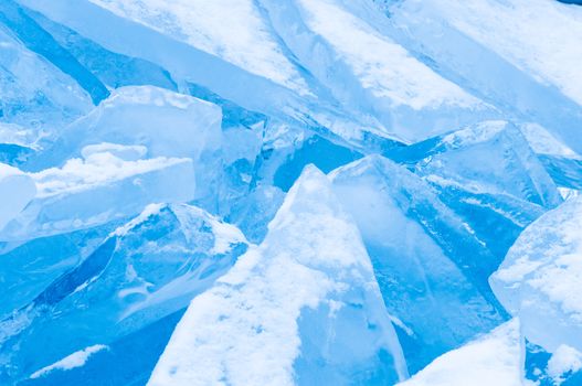 Winter scene at a frozen lake with ice-pack and other ice formations