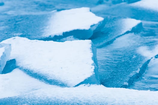 Winter scene at a frozen lake with ice-pack and other ice formations