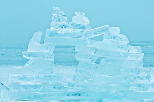 Winter scene at a frozen lake with buildup made of ice bricks