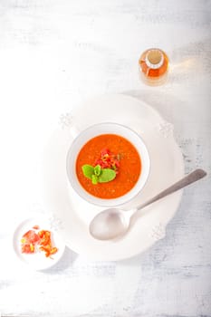 Bowl of fresh tomato soup gazpacho on the table