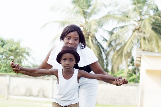 This young woman plays on the field with her son.