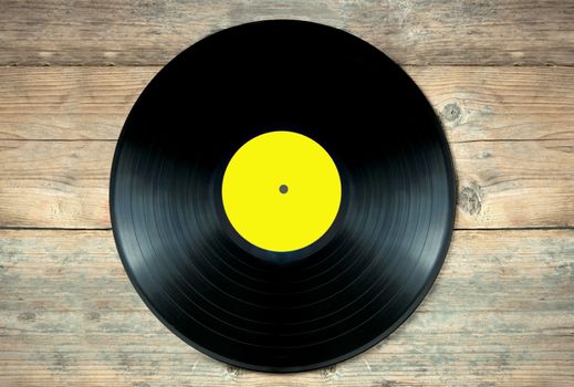 Close up of a vinyl record lp on a wooden table 