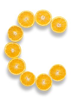 Vitamin C letter made from orange halves over a white background