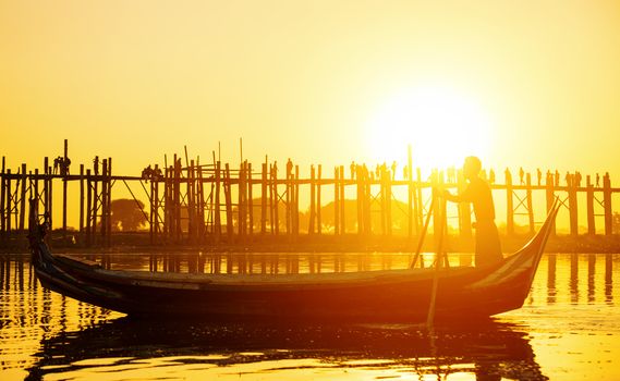 Fishman under U bein bridge at sunset, Myanmar landmark in mandalay