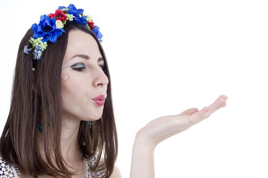 Studio portrait of a young beautiful woman with flower wreath on head.