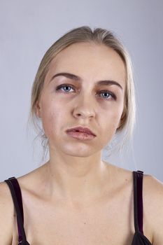 Portrait of a young woman in a gloom on the gray background. Seven Deadly Sins