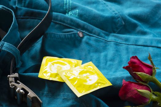 Pack condoms  with roses on pants with belt.Sex or story valentine day.Close up