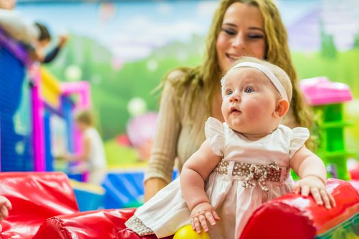 mother and child play in the children's room