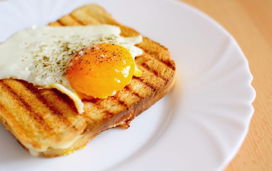 Ham and cheese toast with fried egg on top.