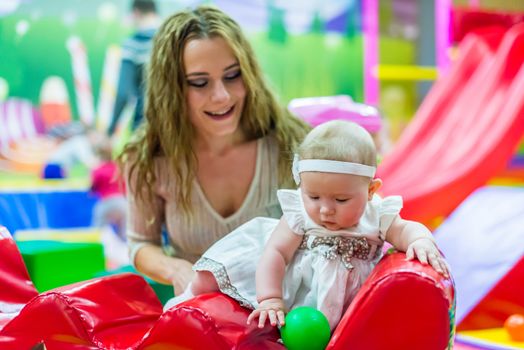 mother and child play in the children's room